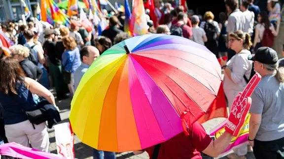 Bunter Regenschirm und Demonstrierende bei der Demo gegen den "Kinderschutzkongress" der AfD in Hannover.