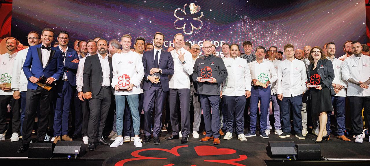 Die Preisträger der Verleihung der Guide-Michelin-Sterne 2025 für deutsche Restaurants stehen bei einem Gruppenbild zusammen.
