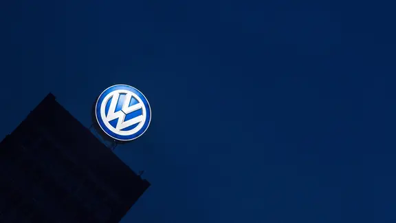 Das Logo des VW-Konzerns leuchtet am Verwaltungshochhaus.