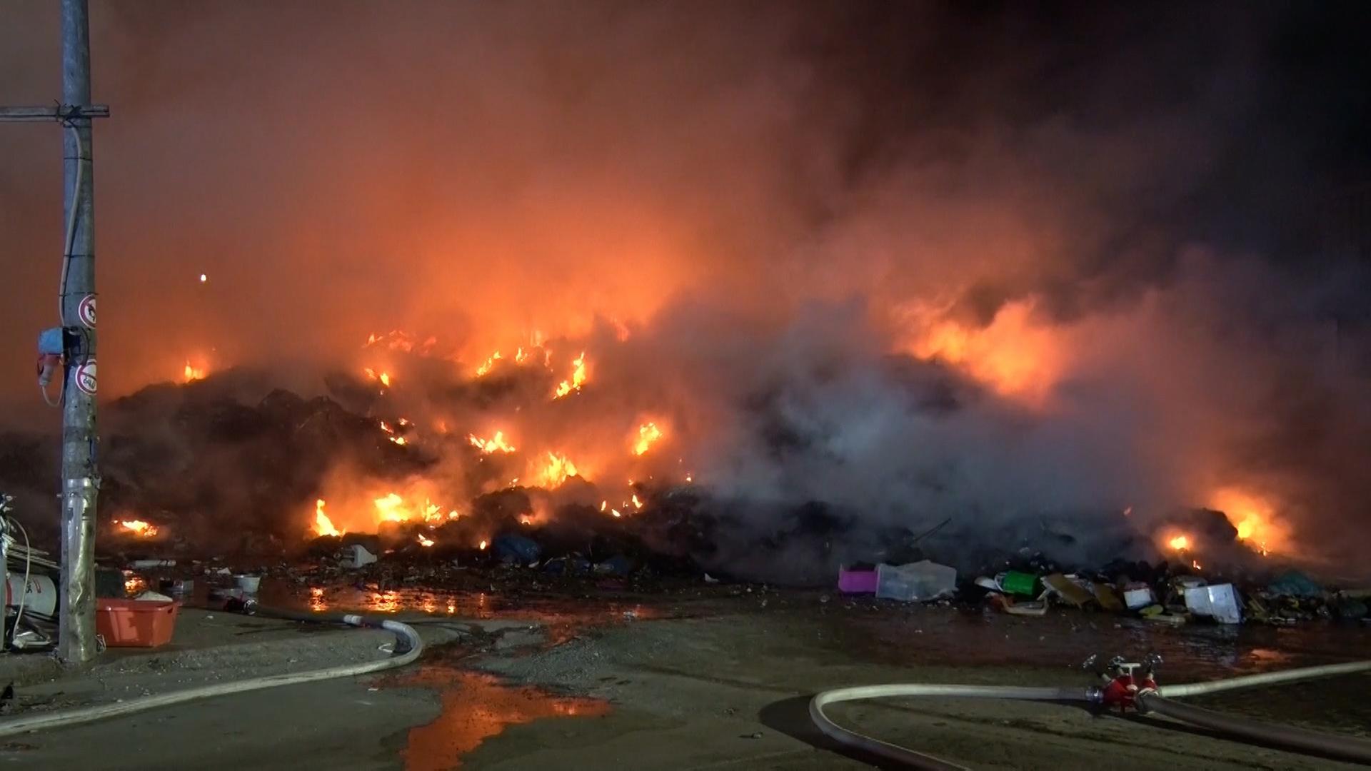 Flammen schlagen bei Nacht aus einem Müllberg. | Nord-West-Media TV