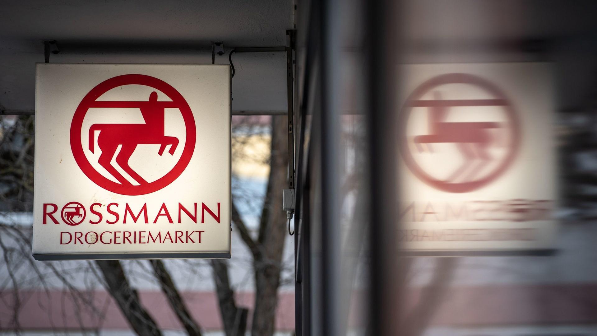 Eine Leuchttafel mit dem Firmenlogo hängt an eine Filiale der Drogeriemarktkette Rossmann in der Mainzer Innenstadt. | picture alliance/dpa, Frank Rumpenhorst
