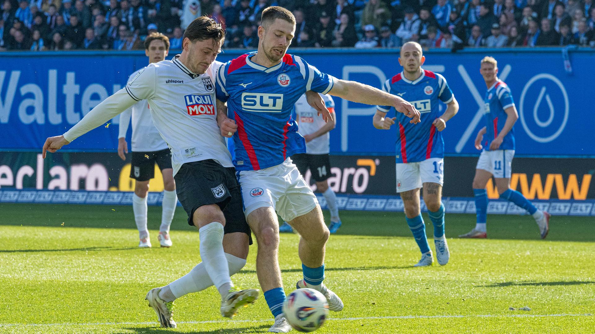 Rostocks Jonas Dirkner (r.) im Zweikampf mit Ulms Jonathan Meier | picture alliance/Fotostand | Voelker