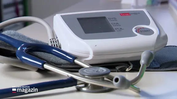 A blood pressure monitor lies on a table.