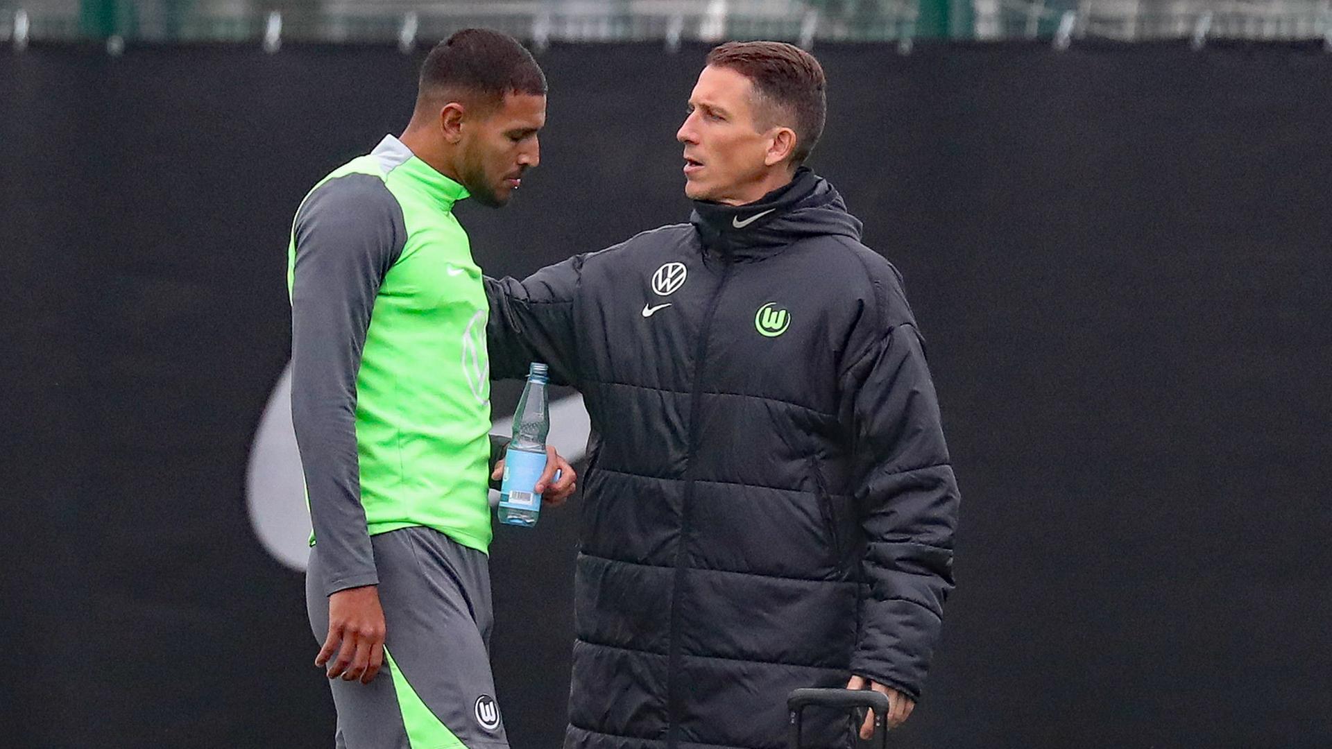 Interimstrainer Daniel Bauer (r.) und Vinicius Souza vom VfL Wolfsburg im Gespräch | IMAGO / Jan Huebner/Franziska Gora