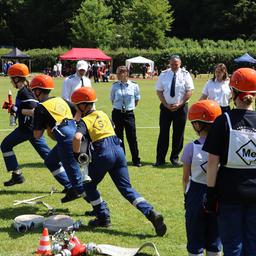 Kinder bei einem Feuerwehrwettkampf.