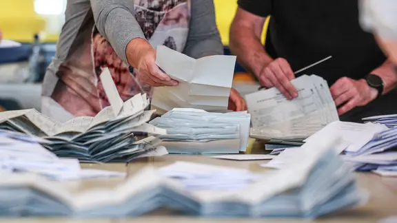 Zahlreiche Wahlhelfer sind mit der Stimmenauszählung der Briefwahlstimmen zur Europawahl beschäftigt.