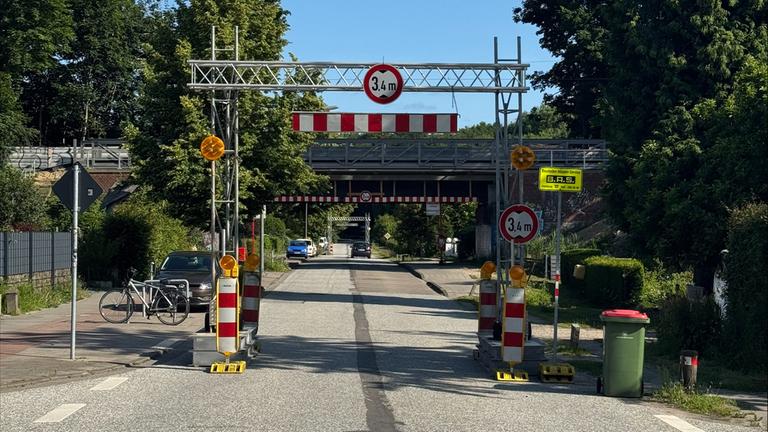 Vor der S-Bahnbrücke in der Rolfinkstraße ist ein Sicherheitstor angebracht.
