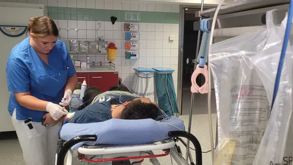 Pflegerin Erika kümmert sich um einen Patienten, der nach einem Arbeitsunfall eingeliefert wurde.