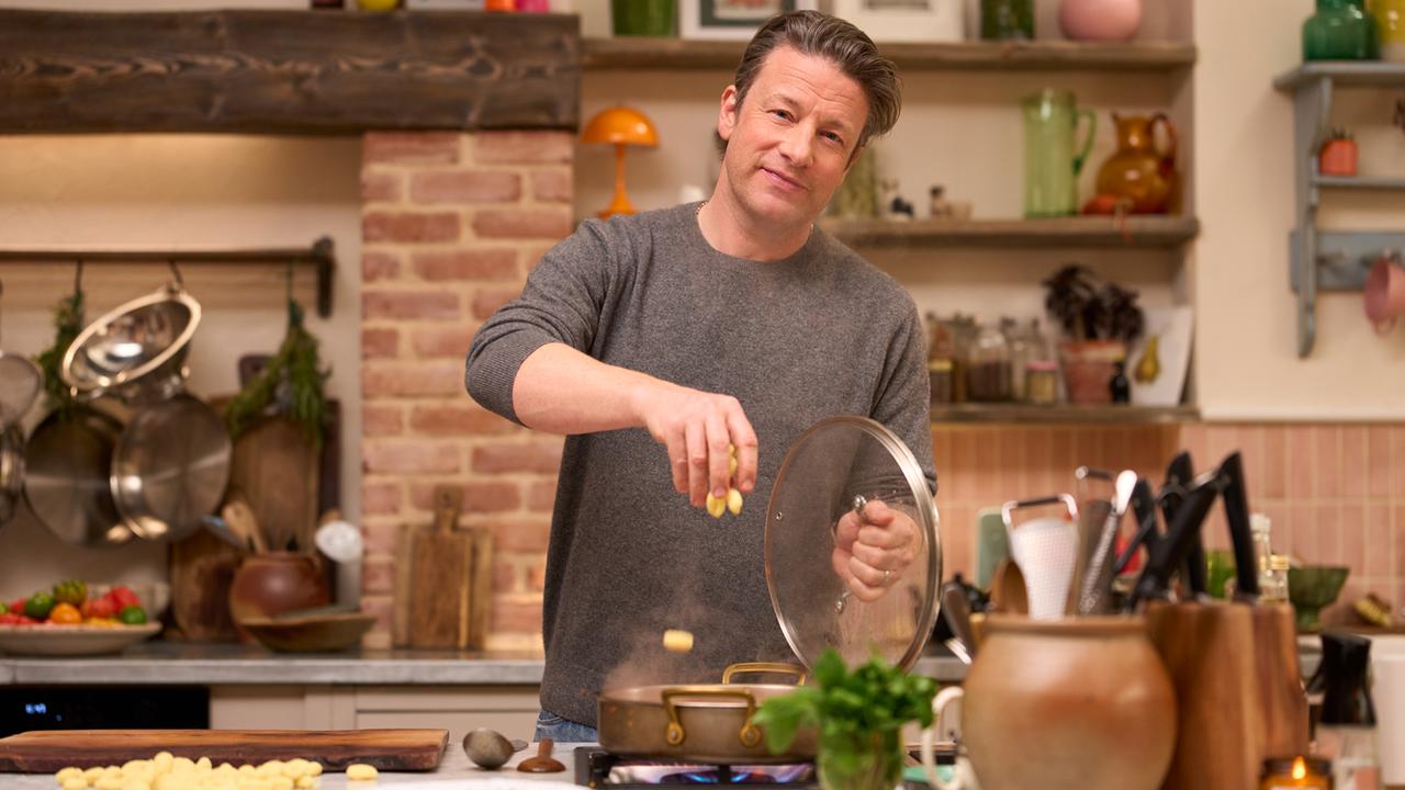 Der englische Starkoch Jamie Oliver steht am Herd