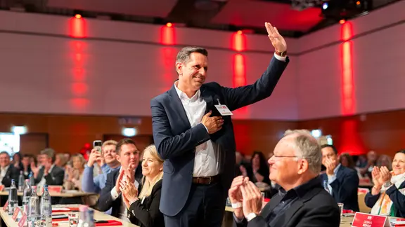 Olaf Lies winkt neben Stephan Weil den Delegierten zu.