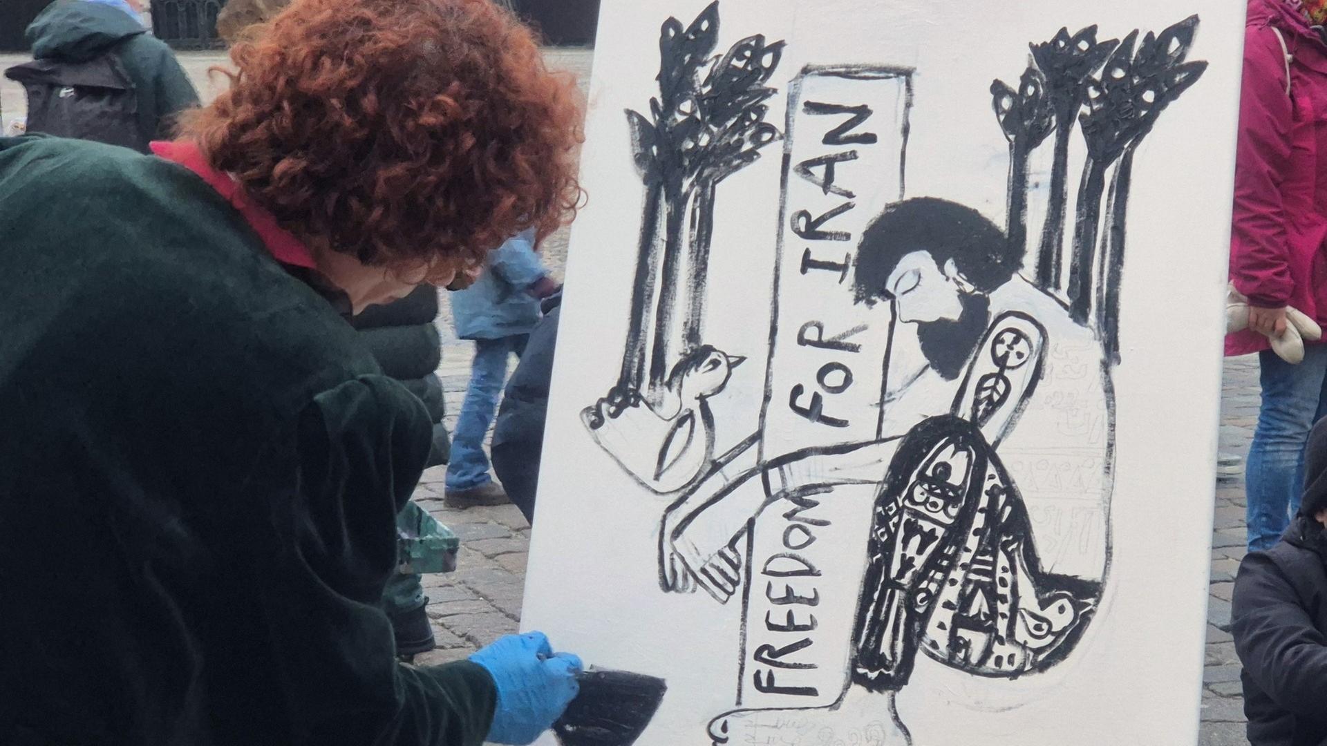 Eine Frau malt ein Bild mit der Aufschrift 