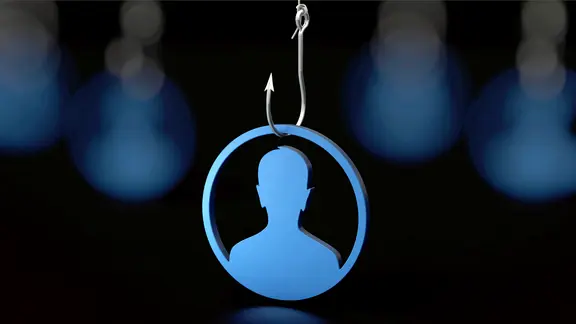 Symbolbild zum Thema Online-Betrug: Eine aus Holz geschnitze Figur hängt an einem Angelhaken. | picture alliance / Zoonar | DesignIt Symbolbild zum Thema Online-Betrug: Eine aus Holz geschnitze Figur hängt an einem Angelhaken.