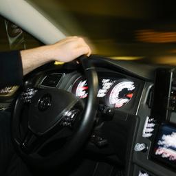 Ein Autofahrer am Steuer eines schnell fahrenden Autos.