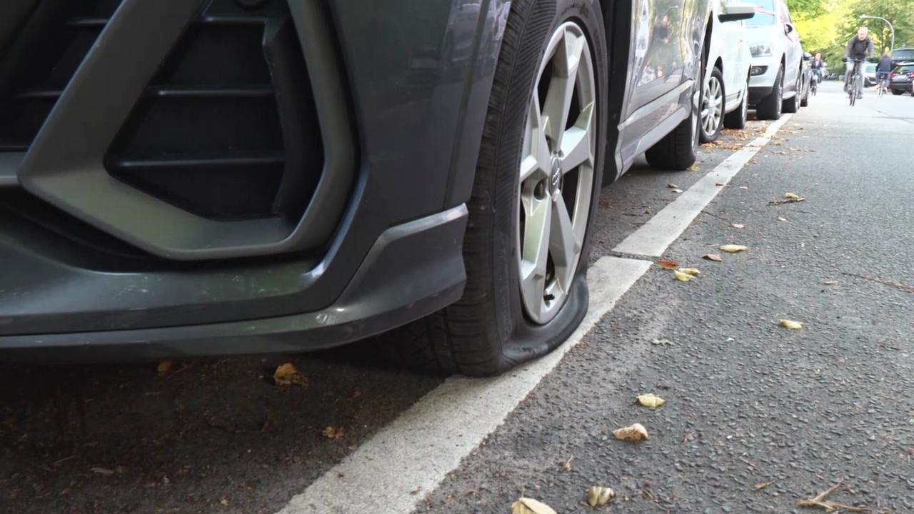 Ein SUV hat einen platten Reifen.