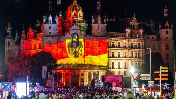 Bei eine Lichtshow, die auf die Fassade des Schweriner Schlosses projiziert wird, können Besucher den Weg von der Friedlichen Revolution 1989 bis heute in Bildern erleben.