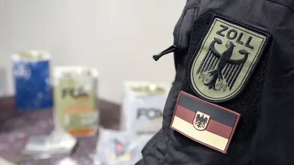 Zollbeamte stehen an einem Tisch im Zollfahndungsamt Hamburg, auf dem Kokain liegt. In fünf Containern aus Paraguay hat der Hamburger Zoll mehr als 16 Tonnen Kokain sichergestellt.